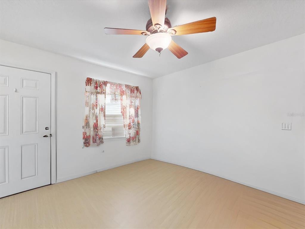 420 Jacks Memorial Road St. Cloud, FL 34769 - Photo 17 of 37 an empty room with windows and fan