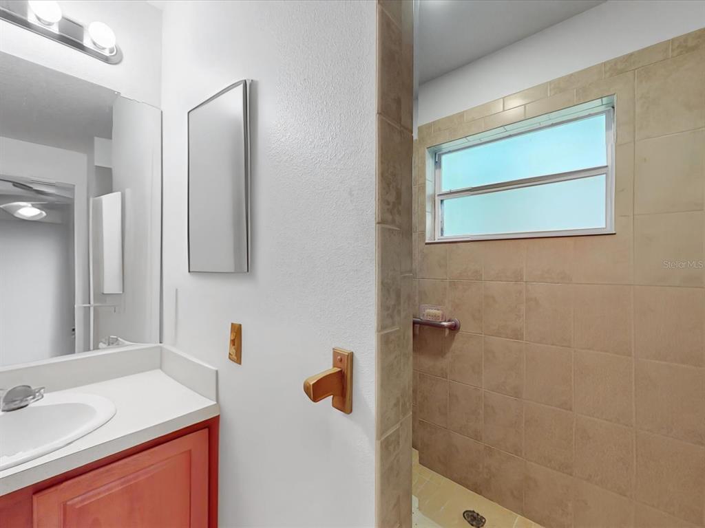 420 Jacks Memorial Road St. Cloud, FL 34769 - Photo 24 of 37 a bathroom with a sink and a mirror