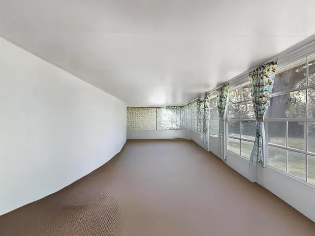 a view of a field with trees in the background