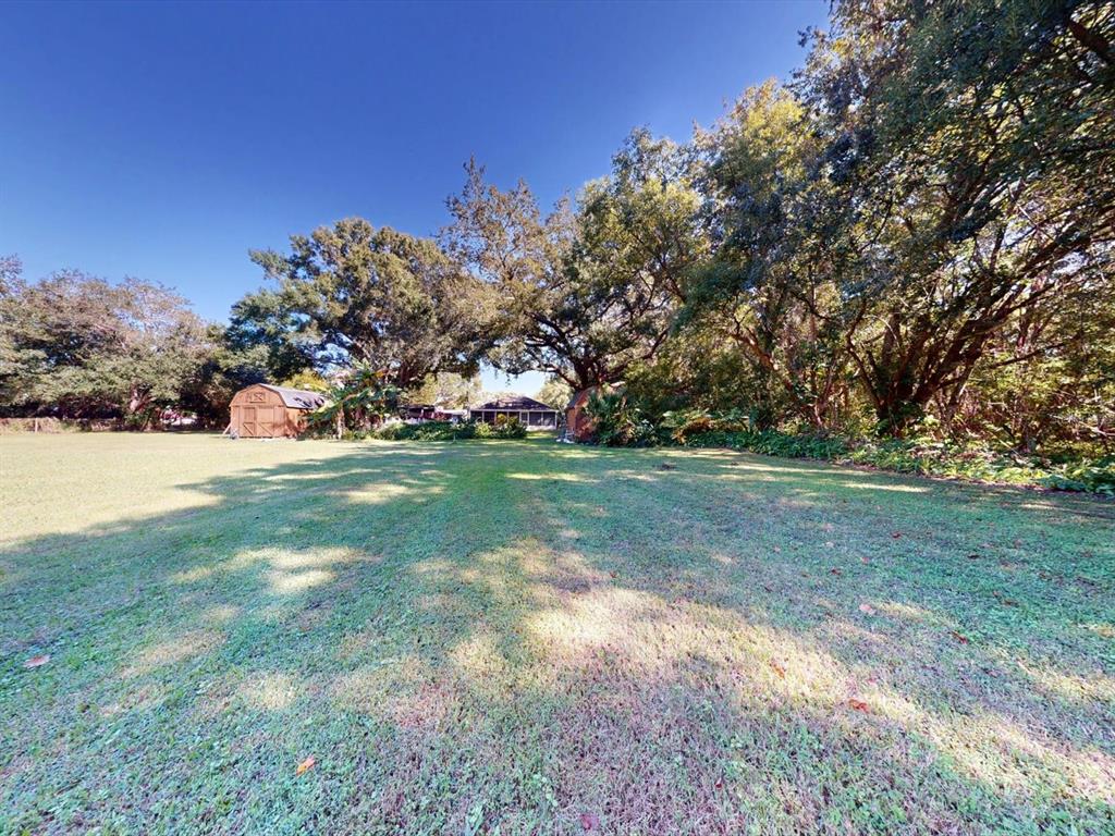 420 Jacks Memorial Road St. Cloud, FL 34769 - Photo 28 of 37 a view of a field with trees in the background