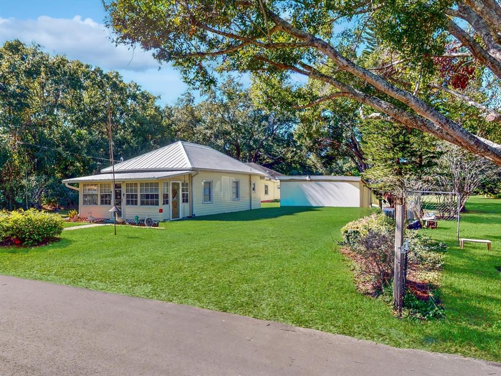 420 Jacks Memorial Road St. Cloud, FL 34769 - Photo 3 of 37 a front view of a house with garden