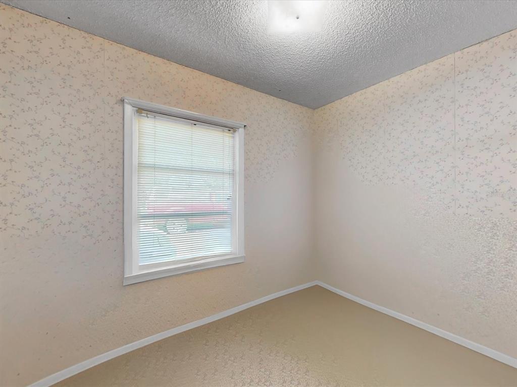 420 Jacks Memorial Road St. Cloud, FL 34769 - Photo 9 of 37 an empty room with a window