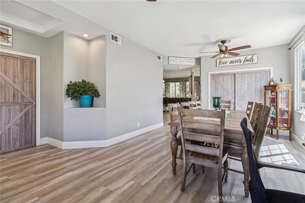 31461 Congressional Drive Temecula, CA 92591 - Photo 14 of 69 a view of a dining room with furniture and wooden floor