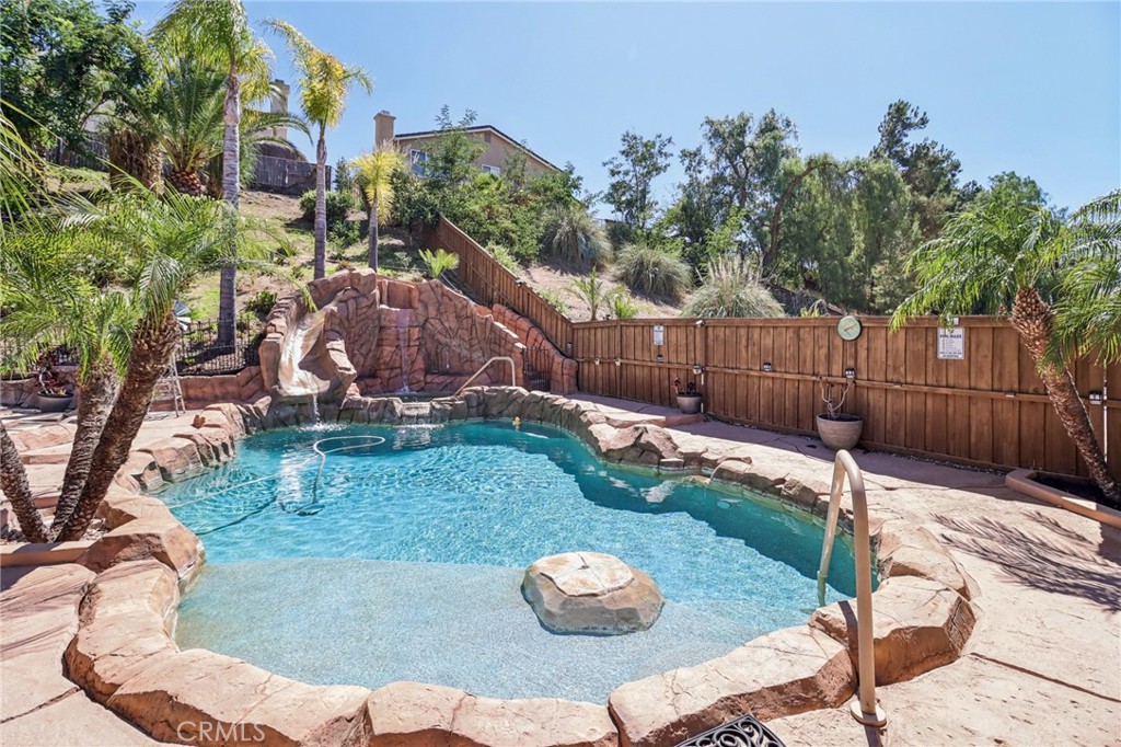 31461 Congressional Drive Temecula, CA 92591 - Photo 2 of 69 a view of a backyard with table and chairs potted plants and wooden fence
