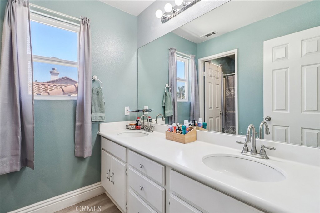 31461 Congressional Drive Temecula, CA 92591 - Photo 29 of 69 a bathroom with a sink double vanity and a mirror