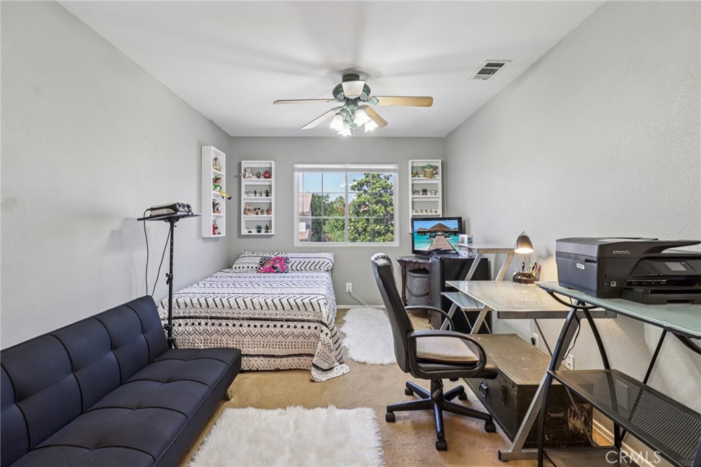 31461 Congressional Drive Temecula, CA 92591 - Photo 34 of 69 a bedroom with furniture and a chandelier