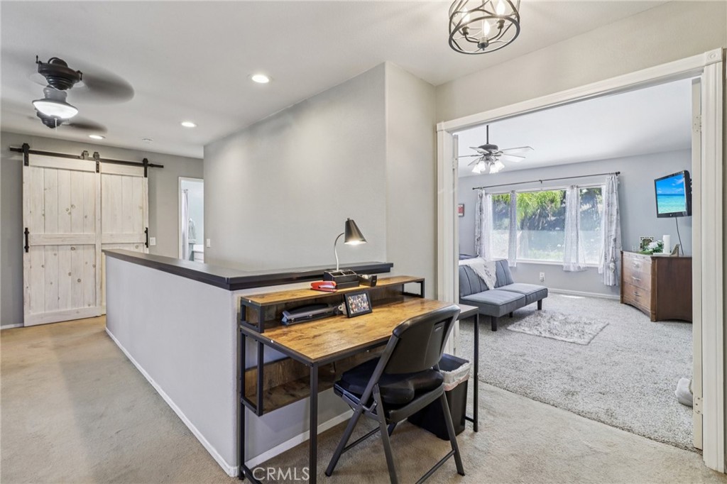 31461 Congressional Drive Temecula, CA 92591 - Photo 36 of 69 a outdoor kitchen with a table chairs and a refrigerator