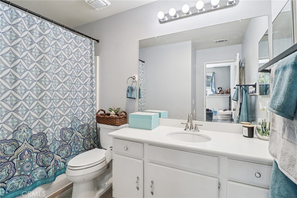 31461 Congressional Drive Temecula, CA 92591 - Photo 53 of 69 a bathroom with a sink a toilet and a mirror