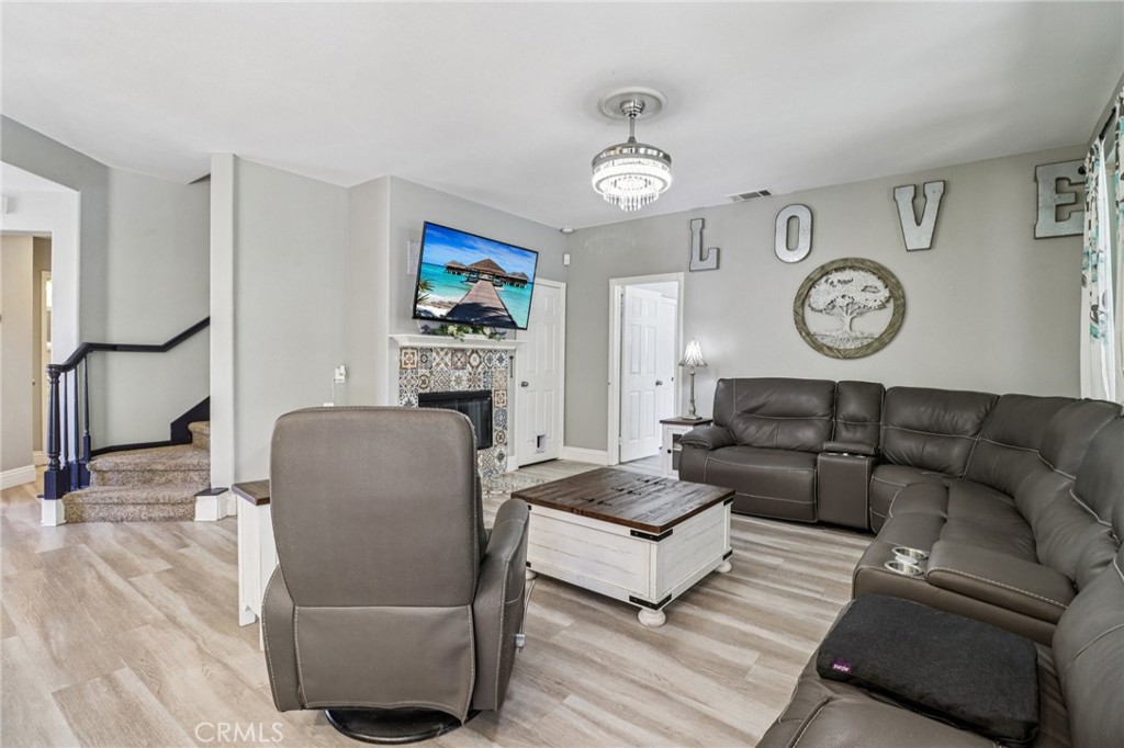 31461 Congressional Drive Temecula, CA 92591 - Photo 10 of 69 a living room with furniture a clock and a window