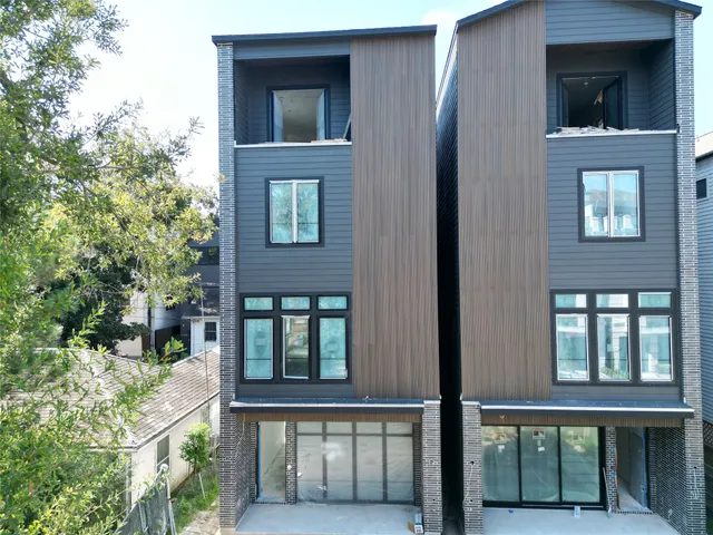 front view of a brick house with a large window