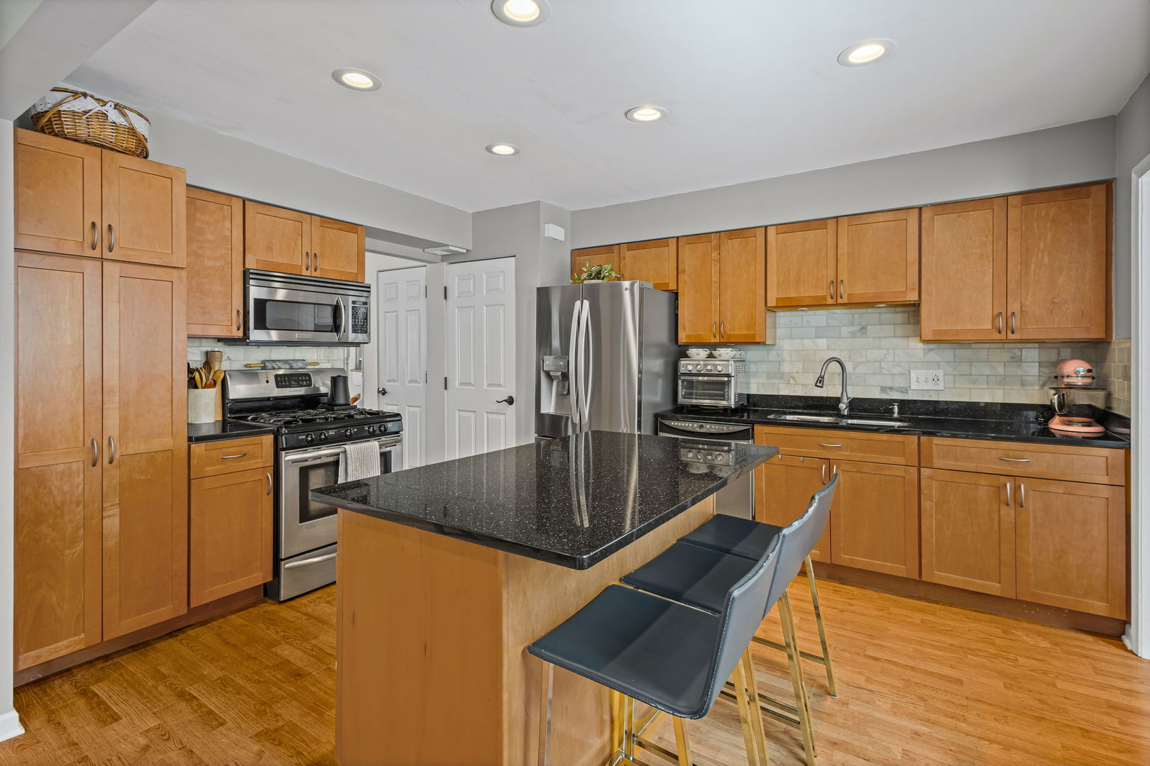 42 West Taylor Road Lombard, IL 60148 - Photo 8 of 36 a kitchen with stainless steel appliances granite countertop a refrigerator a stove top oven a sink and cabinets