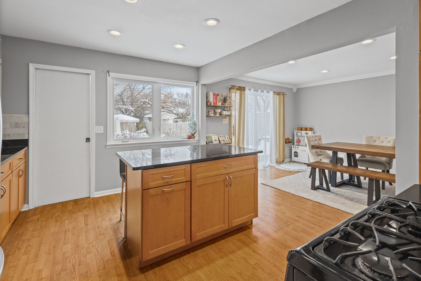 42 West Taylor Road Lombard, IL 60148 - Photo 10 of 36 a kitchen with stainless steel appliances granite countertop a stove a refrigerator a dining table and chairs with wooden floor