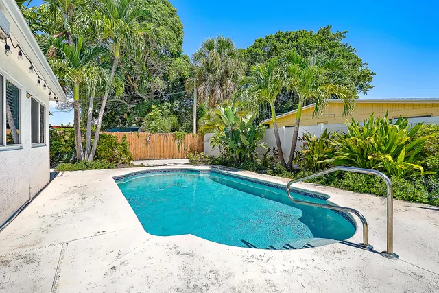 a view of a swimming pool with a yard