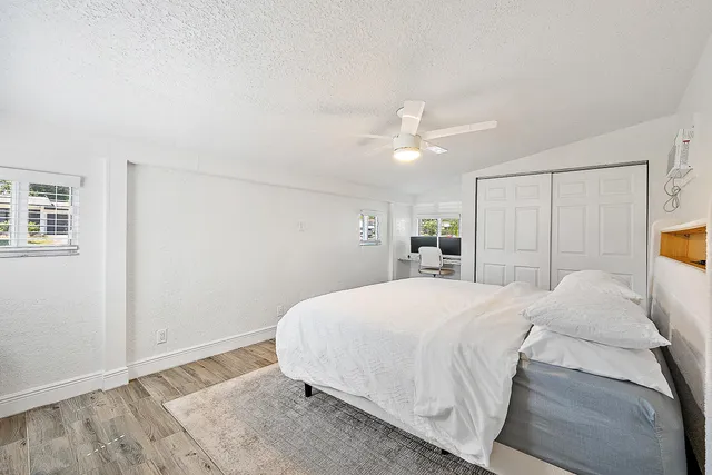 a spacious bedroom with a bed and a window