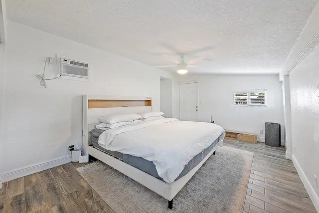 a bedroom with a bed and a night stand