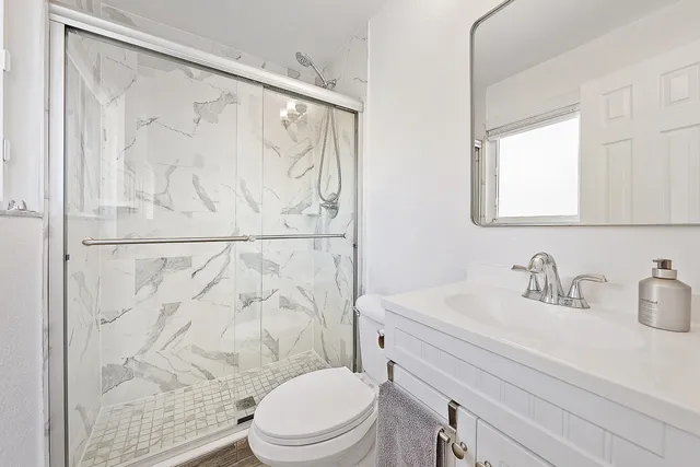 a bathroom with a sink a toilet and shower curtain
