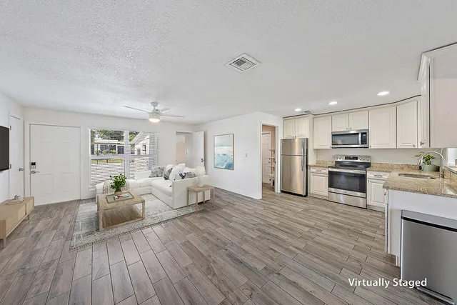 a living room with furniture and kitchen view