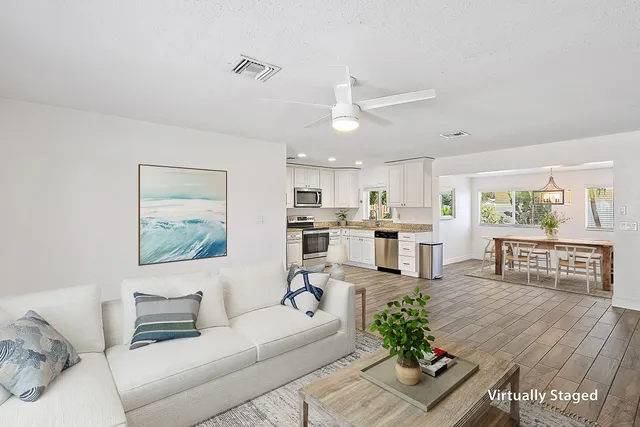 a living room with furniture and kitchen view