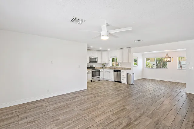 a view of kitchen with wooden floor and window