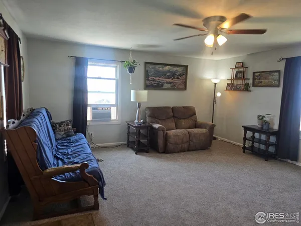 a view of livingroom with furniture and a ceiling fan