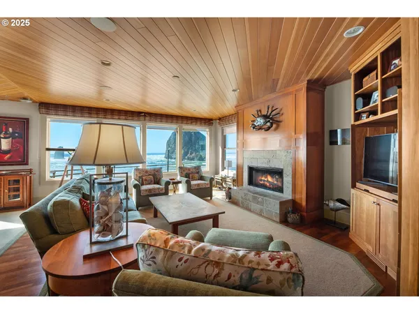 a kitchen with stainless steel appliances kitchen island granite countertop a table chairs and a refrigerator