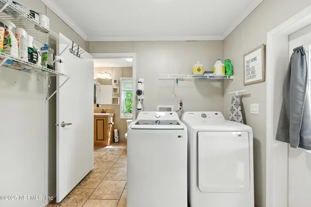 a view of washer and dryer with kitchen in the background