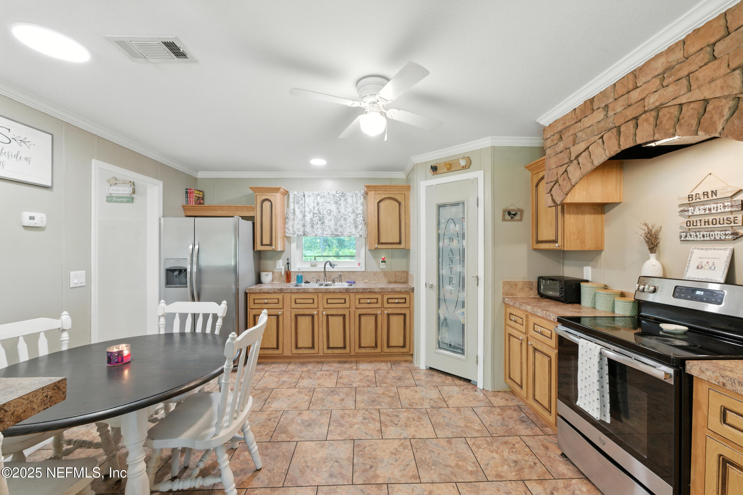 44586 Maplewood Court Callahan, FL 32011 - Photo 8 of 20 a large kitchen with stainless steel appliances granite countertop a stove and a refrigerator