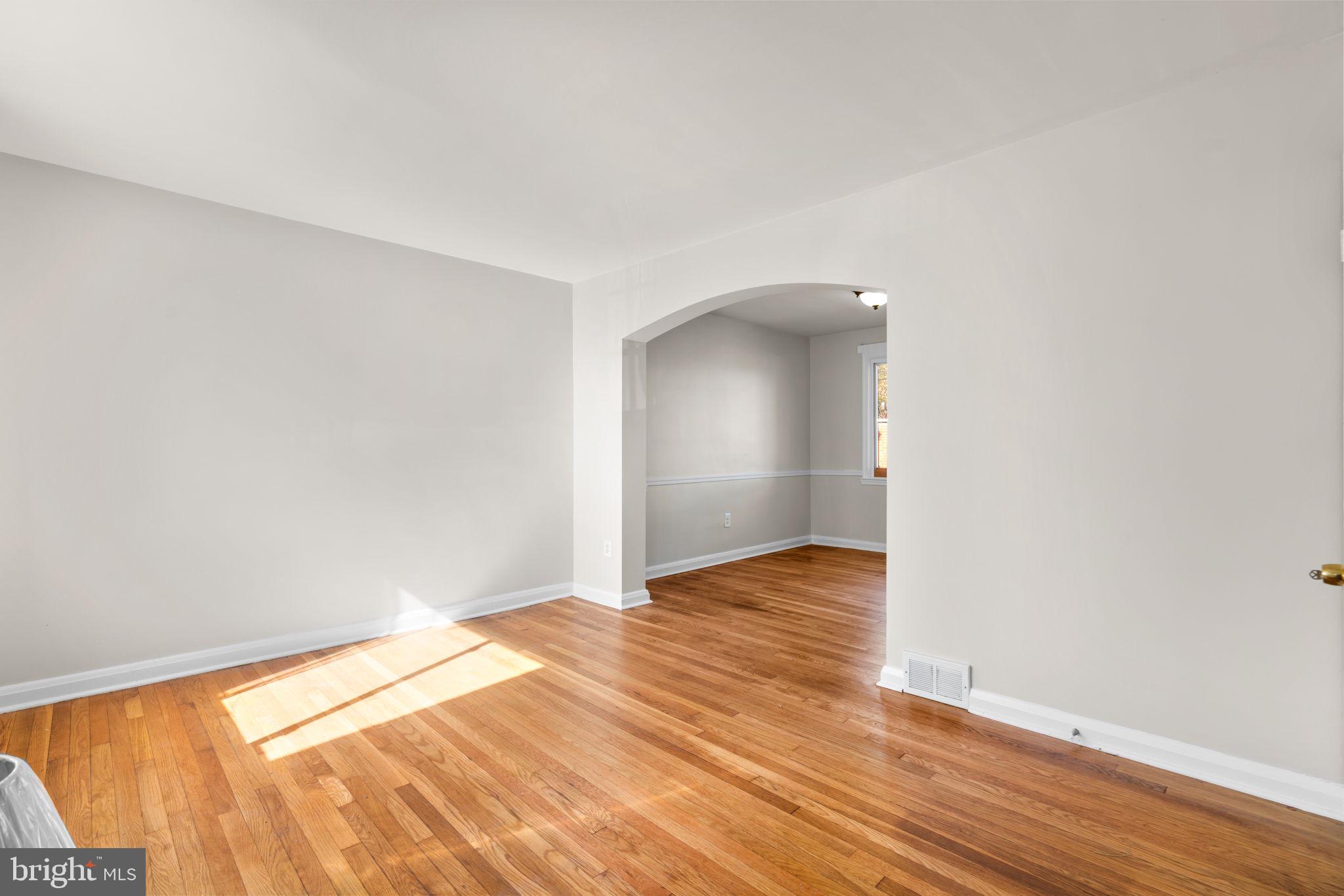 1420 Cedarcroft Road Baltimore, MD 21239 - Photo 4 of 28 a view of an empty room and wooden floor