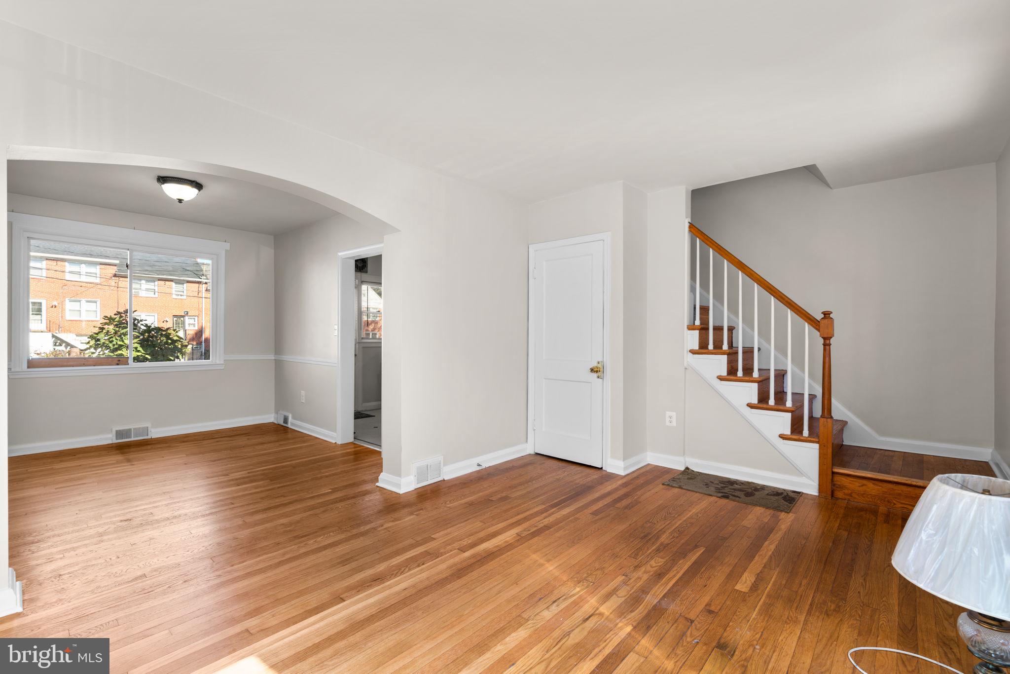 1420 Cedarcroft Road Baltimore, MD 21239 - Photo 6 of 28 a view of an empty room with wooden floor and a window