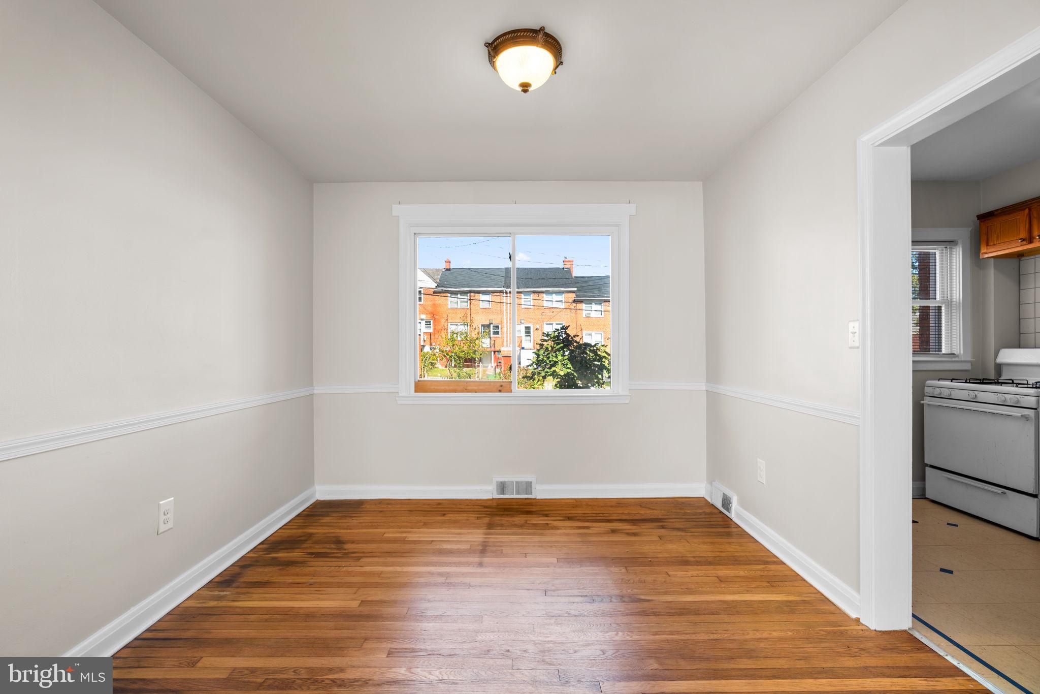1420 Cedarcroft Road Baltimore, MD 21239 - Photo 8 of 28 a view of empty room with wooden floor and fan