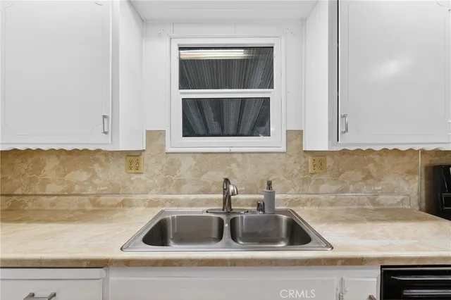 a kitchen with a sink a stove a refrigerator and cabinets