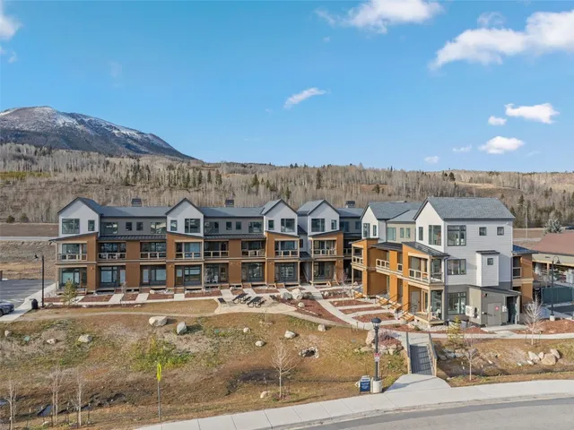 a front view of a building and a mountain view