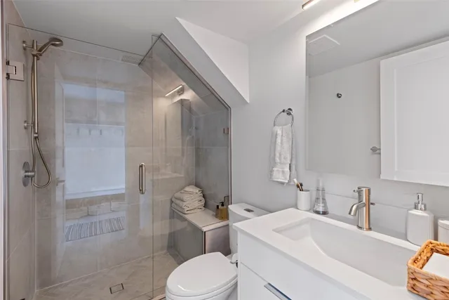 a bathroom with a sink toilet and shower