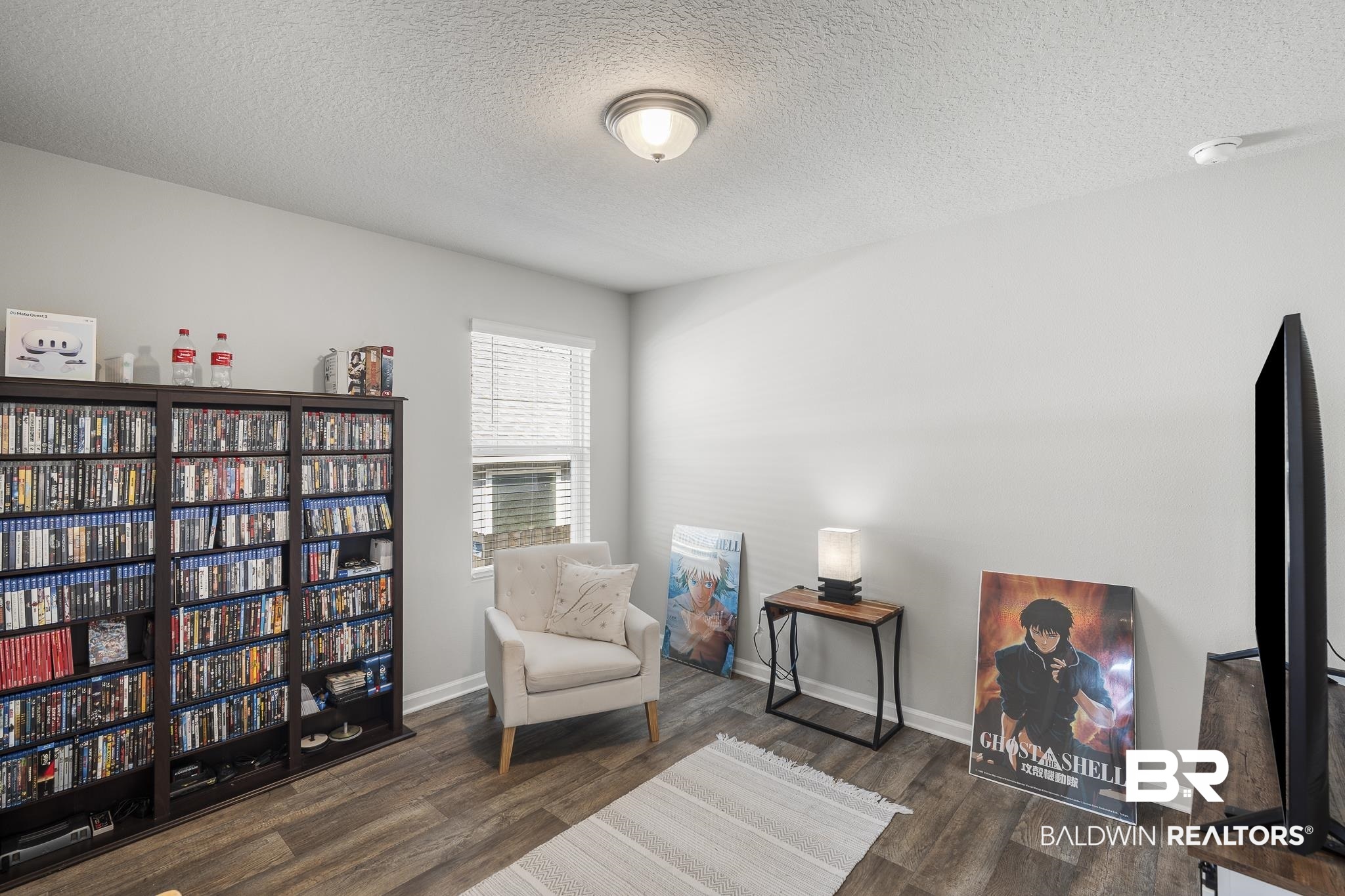 10232 Brodick Loop Spanish Fort, AL 36527 - Photo 21 of 29 Living area featuring a textured ceiling, wood finished floors, and baseboards