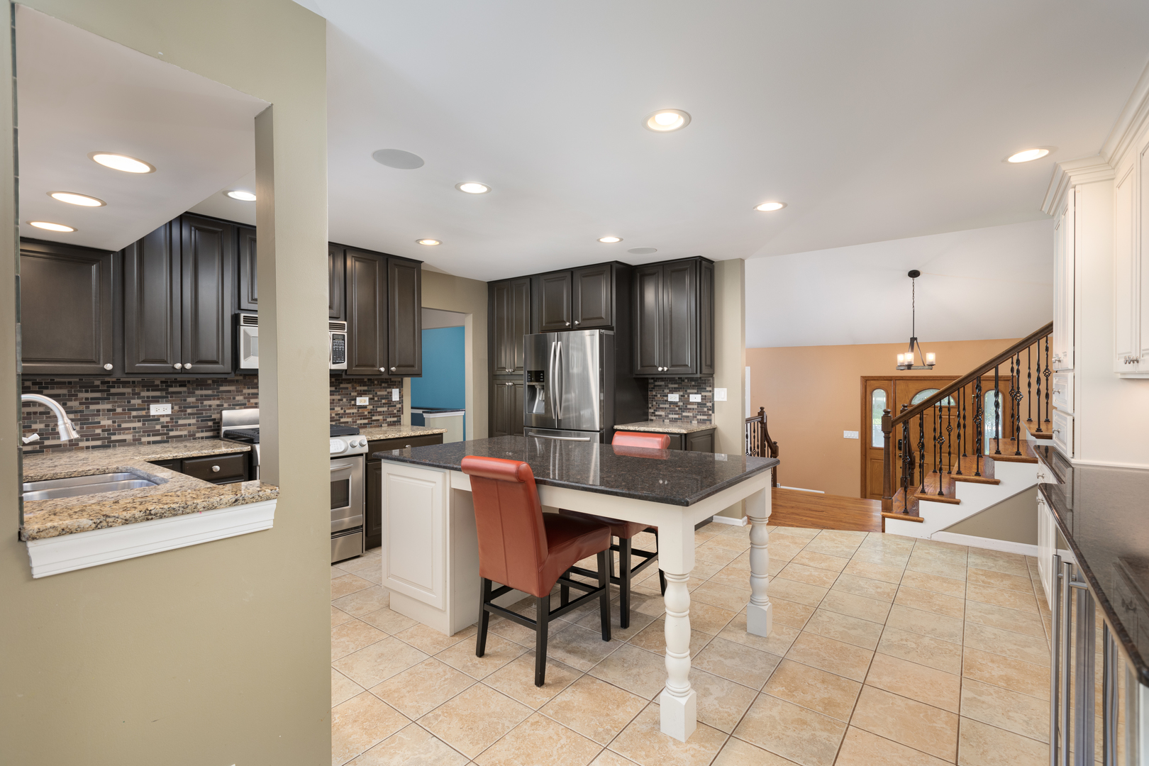 729 East Bauer Road Naperville, IL 60563 - Photo 11 of 57 a kitchen with stainless steel appliances kitchen island granite countertop a refrigerator and cabinets