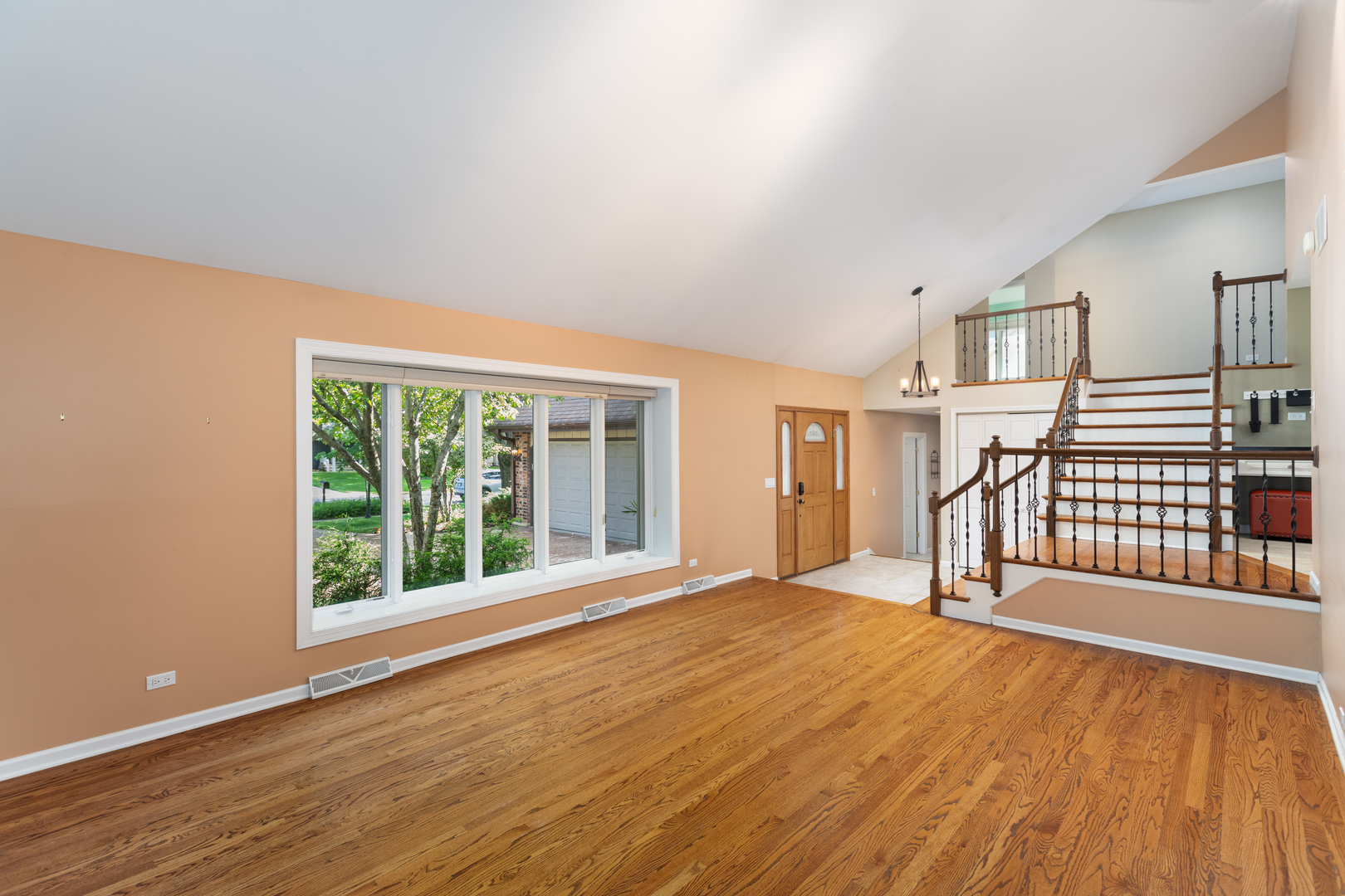 729 East Bauer Road Naperville, IL 60563 - Photo 16 of 57 a view of an empty room with wooden floor and a window