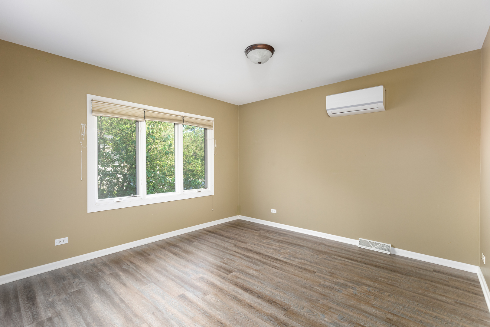 729 East Bauer Road Naperville, IL 60563 - Photo 39 of 57 a view of an empty room with wooden floor and a window