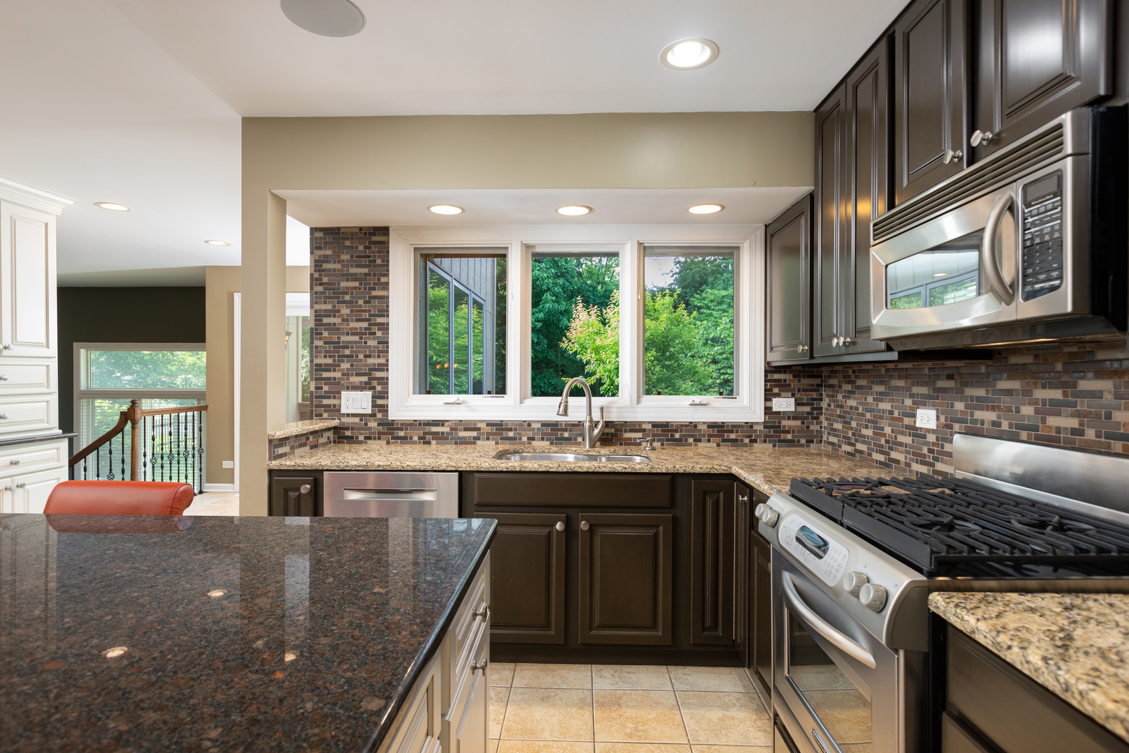 729 East Bauer Road Naperville, IL 60563 - Photo 7 of 57 a kitchen with stainless steel appliances granite countertop a stove a sink and a microwave