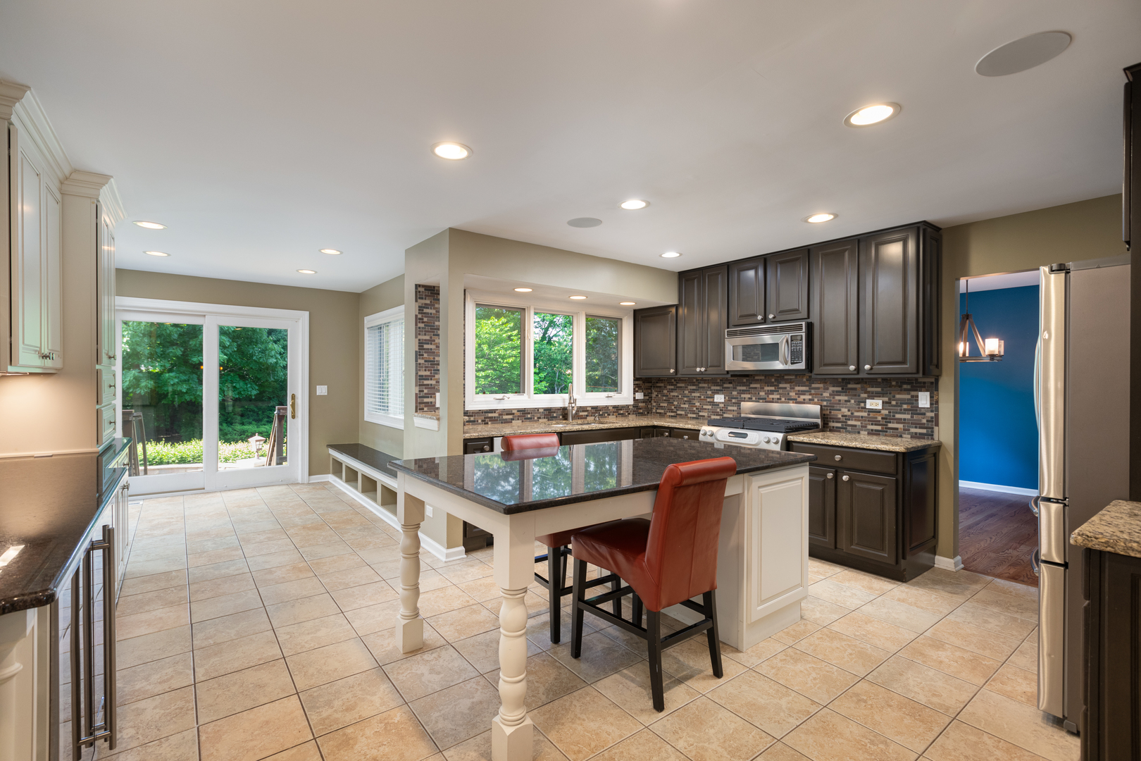729 East Bauer Road Naperville, IL 60563 - Photo 8 of 57 a kitchen with kitchen island granite countertop wooden cabinets a counter top space and stainless steel appliances