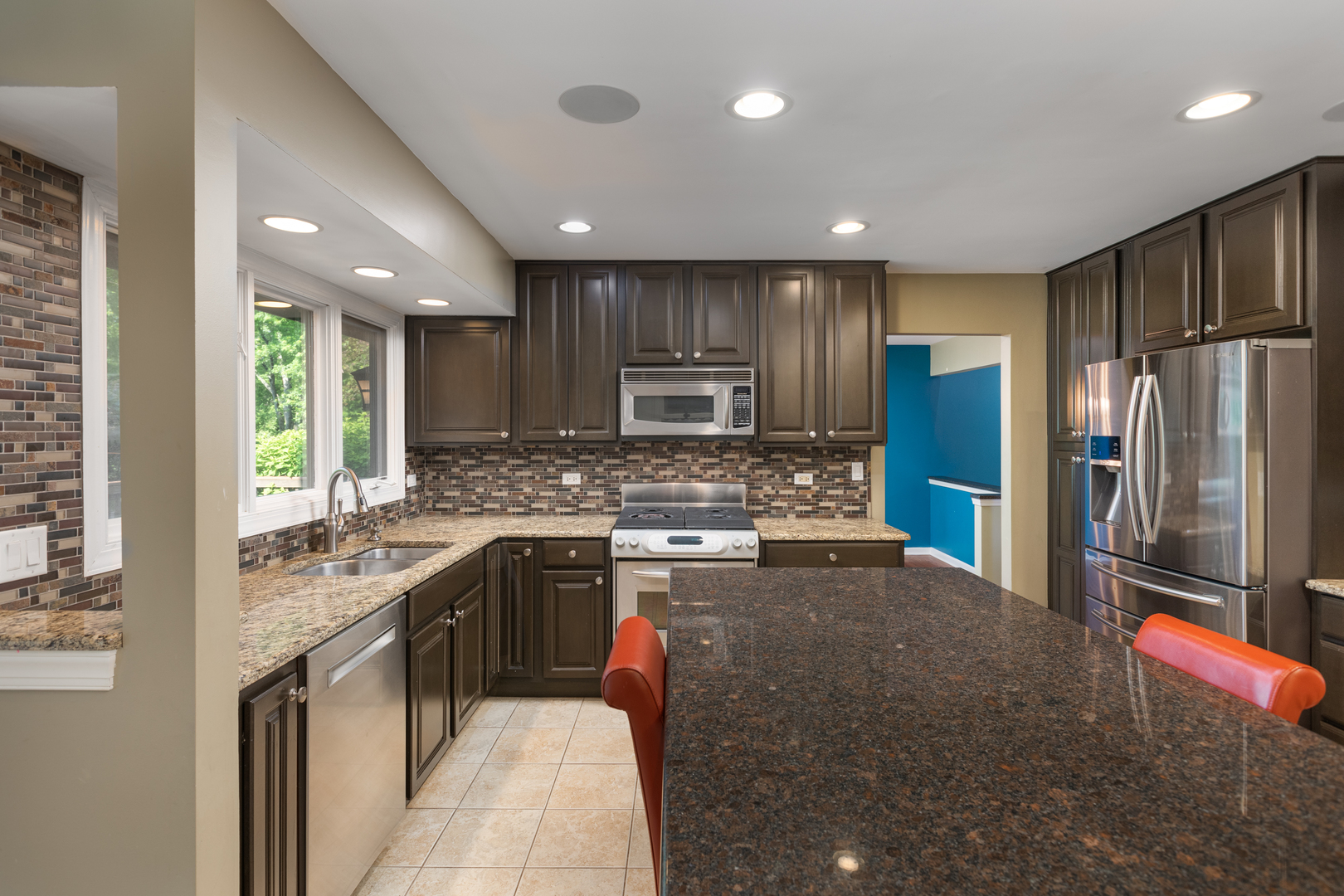 729 East Bauer Road Naperville, IL 60563 - Photo 10 of 57 a kitchen with stainless steel appliances granite countertop counter space a sink refrigerator and cabinets