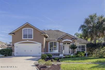 32330 Sunny Parke Drive Fernandina Beach, FL 32034 - Photo 1 of 38 a front view of a house with a garden and plants