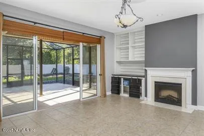 a view of an empty room with a fireplace and a window