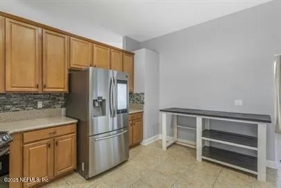 a kitchen with stainless steel appliances a refrigerator and cabinets