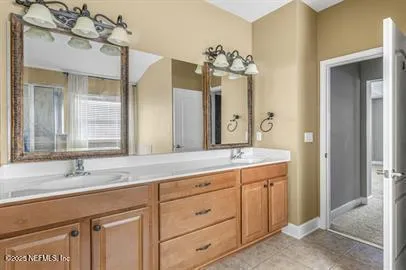 a bathroom with a granite countertop sink a toilet and a shower