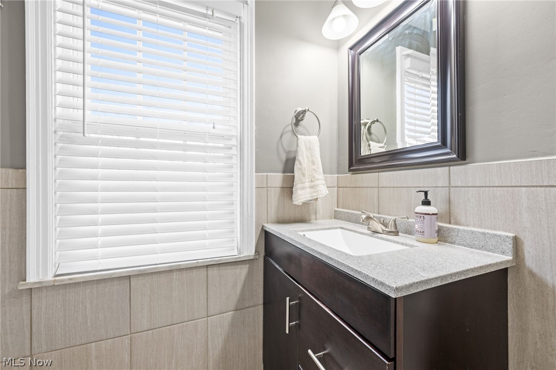 2368 Ashurst Road Cleveland, OH 44118 - Photo 14 of 20 Bathroom with backsplash, oversized vanity, and a wealth of natural light