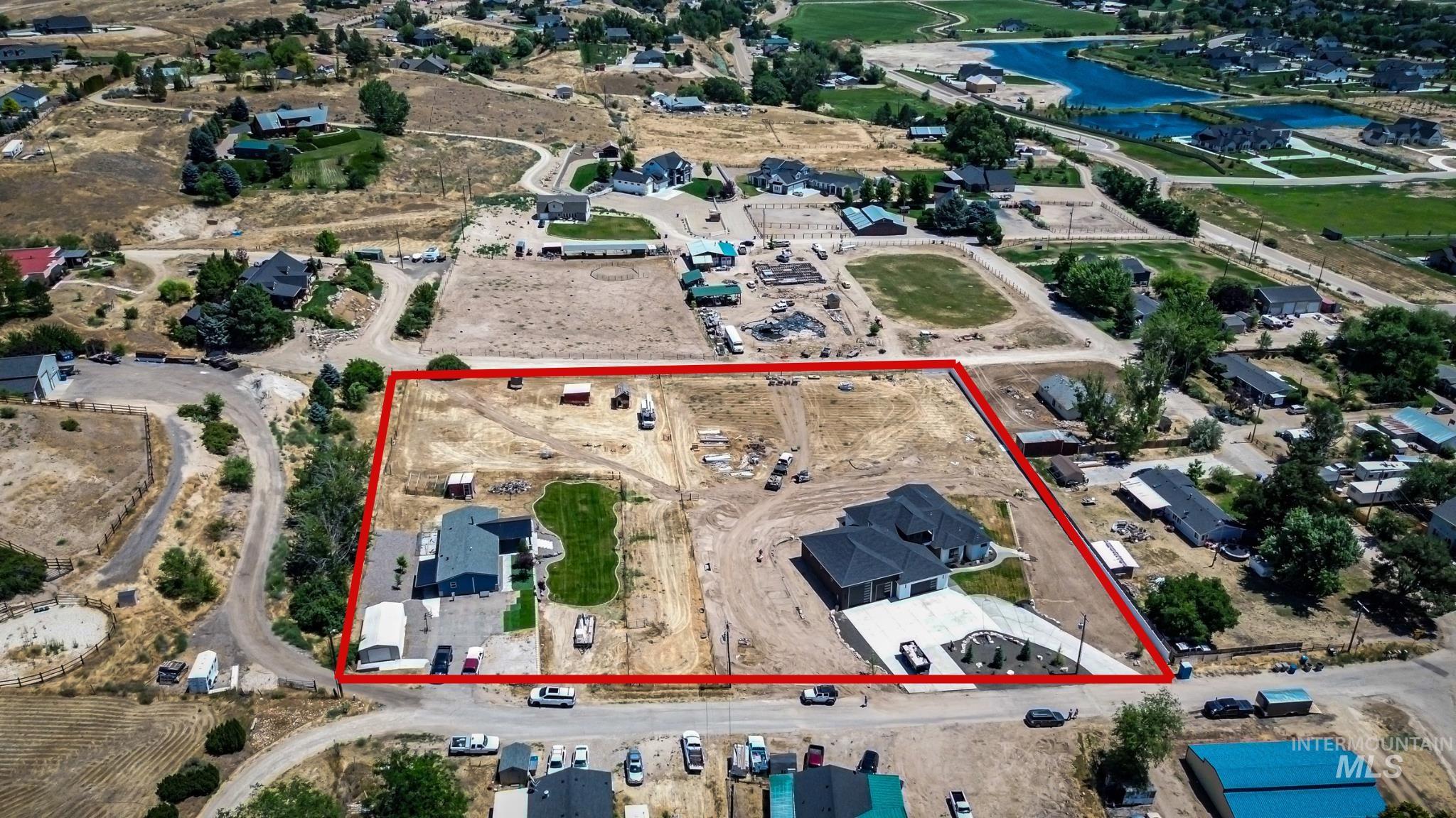23904 Southview Lane Middleton, ID 83644 - Photo 2 of 29 Expansive lot featuring two distinct residences, a large manicured lawn area, and substantial paved driveways