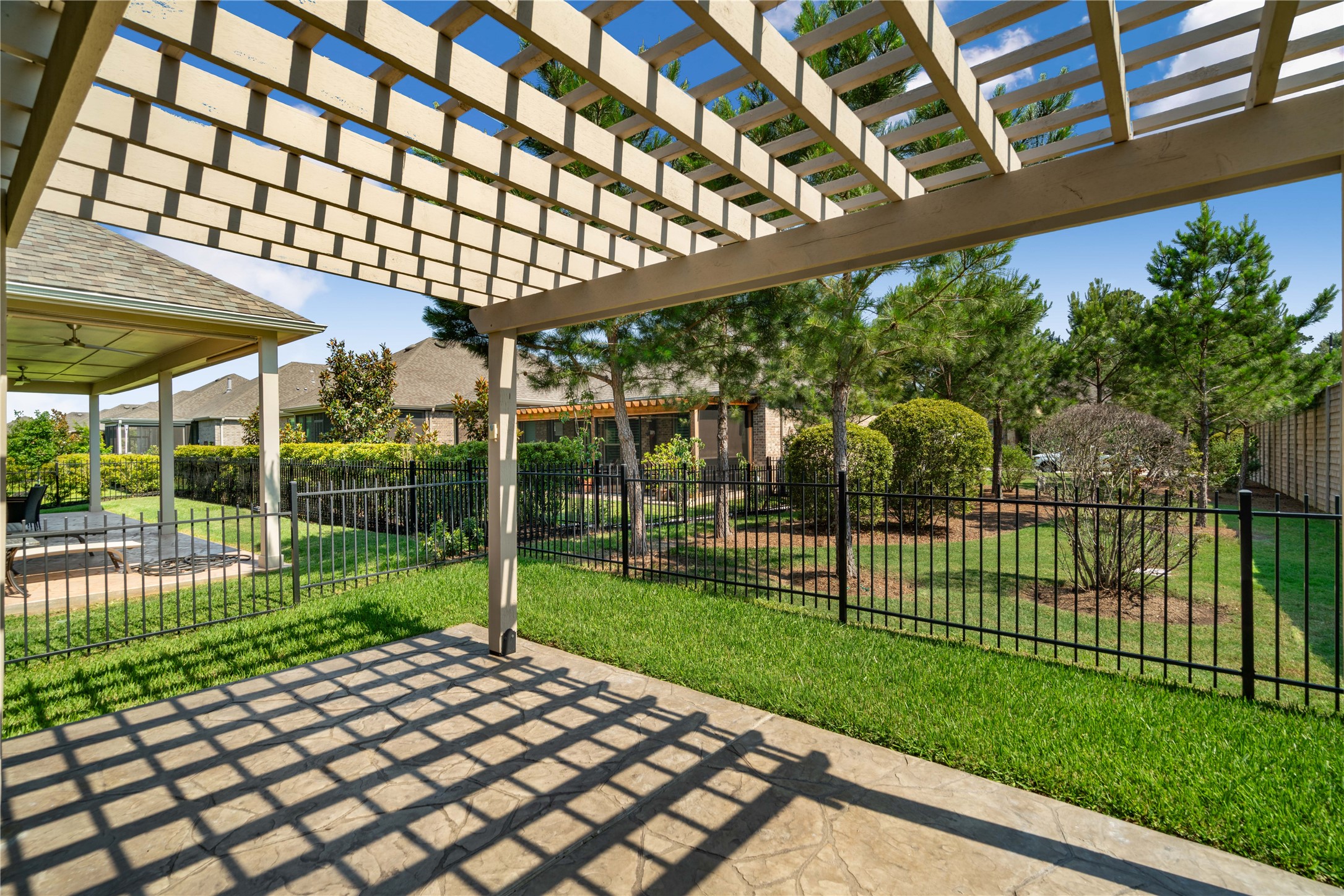 516 Nokota Drive Spring, TX 77382 - Photo 2 of 33 Enjoy a nice afternoon out under the pergola while sipping on your favorite beverage or reading your favorite book. With no direct back neighbors you have more privacy and a beautiful green space to admire!
