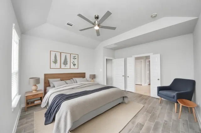 a bedroom with a bed and a chair