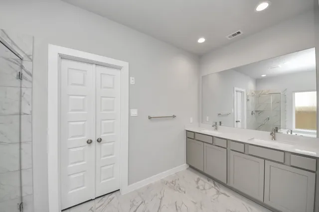 a bathroom with a double vanity sink and mirror