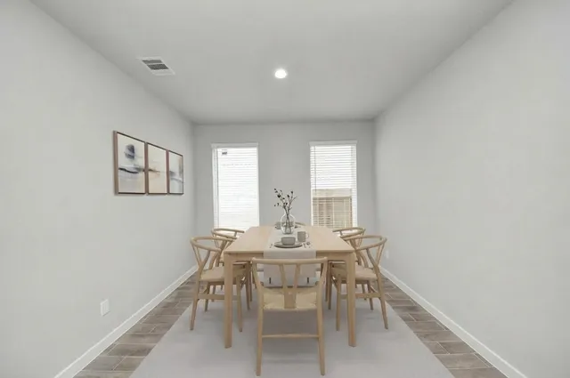 a view of a dining room with furniture and window
